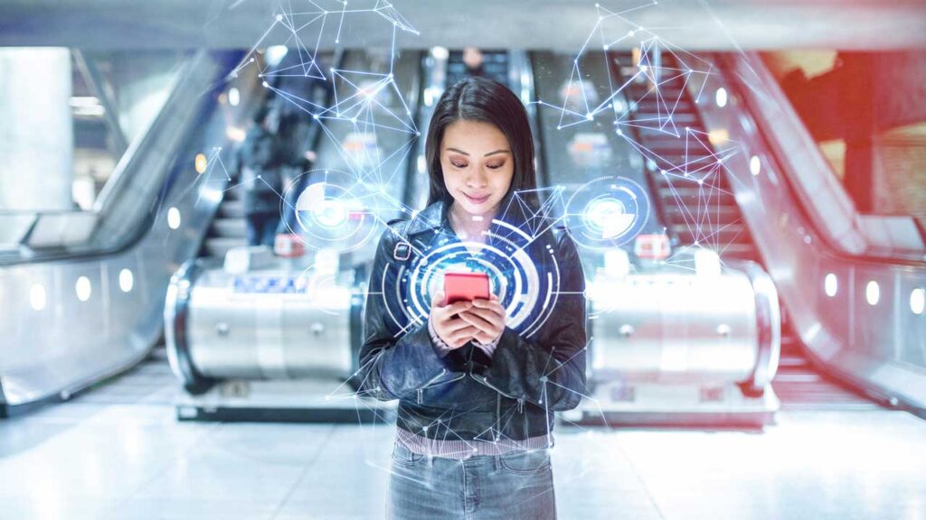girl looking at phone in front of mall escalators