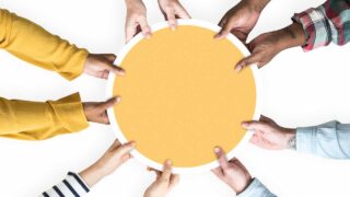 many hands holding a disk