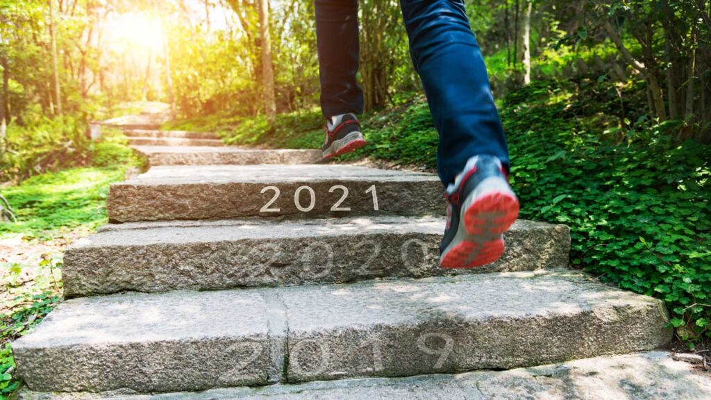 person going up stairs with years marked on them