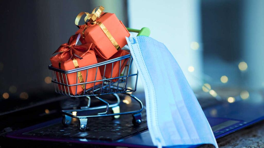 artistic photo of a cart with wrapped presents and a medical mask