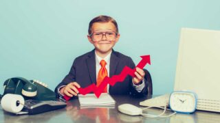 child holding upward trajectory arrow