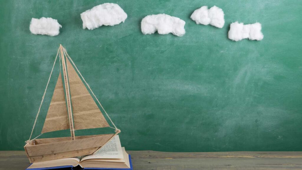 toy boat with cotton ball clouds