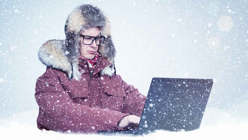 person typing in a winter storm