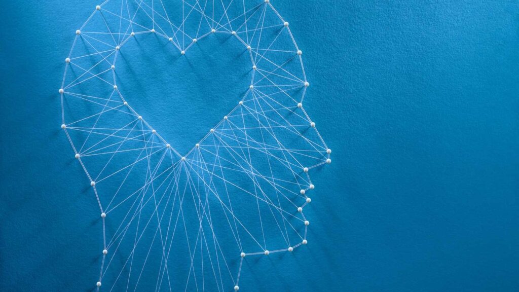 thread art of a human profile with a heart