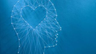 thread art of a human profile with a heart