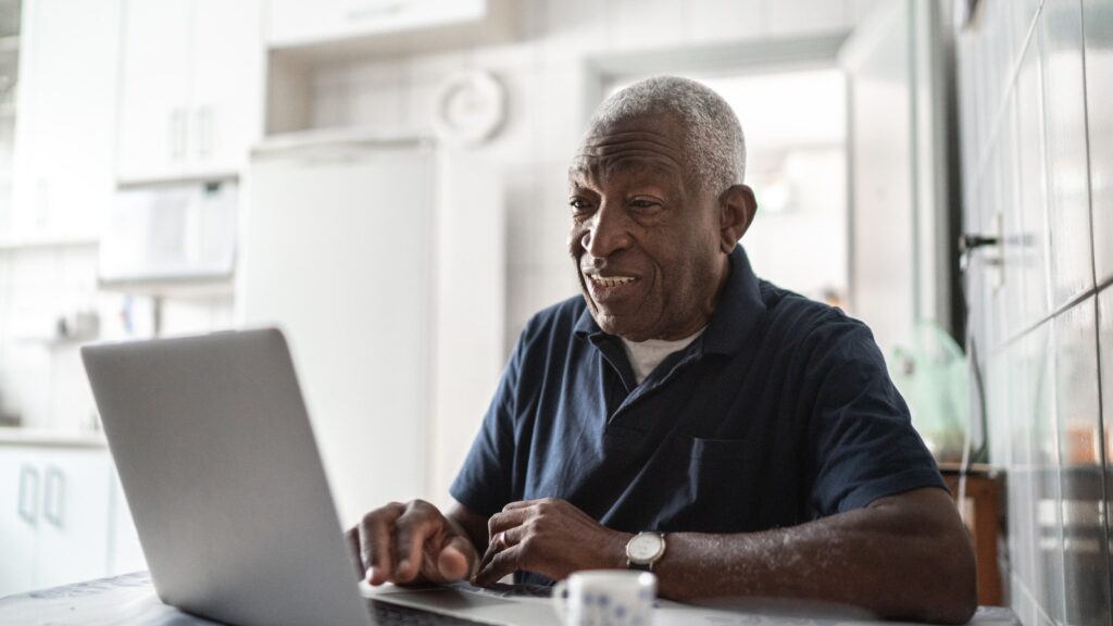 senior black man on laptop