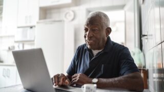 senior black man on laptop