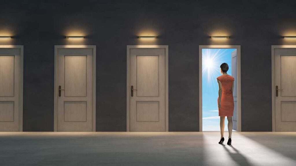 woman in hall of doors, entering one