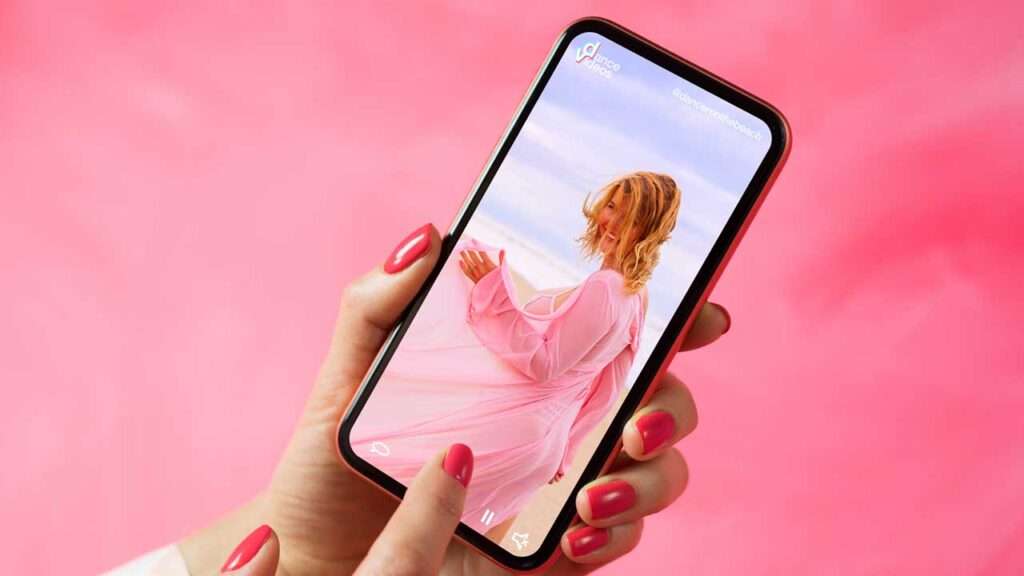 person holding phone with woman on screen