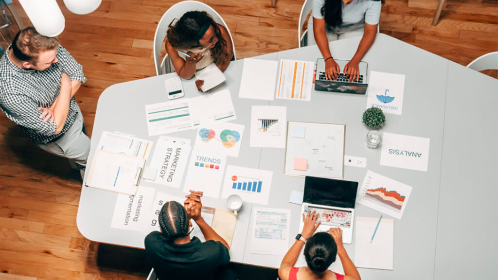 photo of people working together at a large table