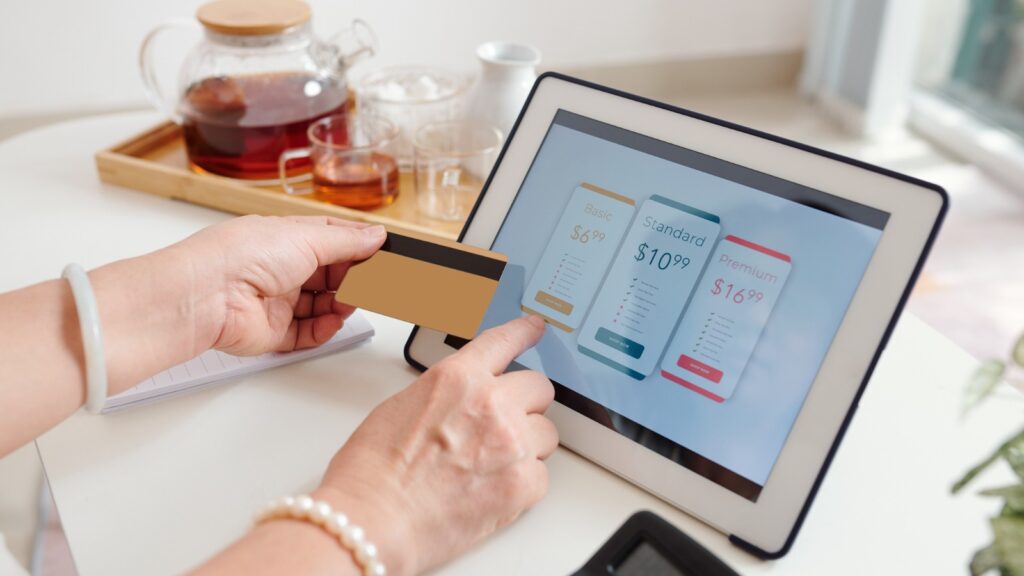 person using credit card on tablet