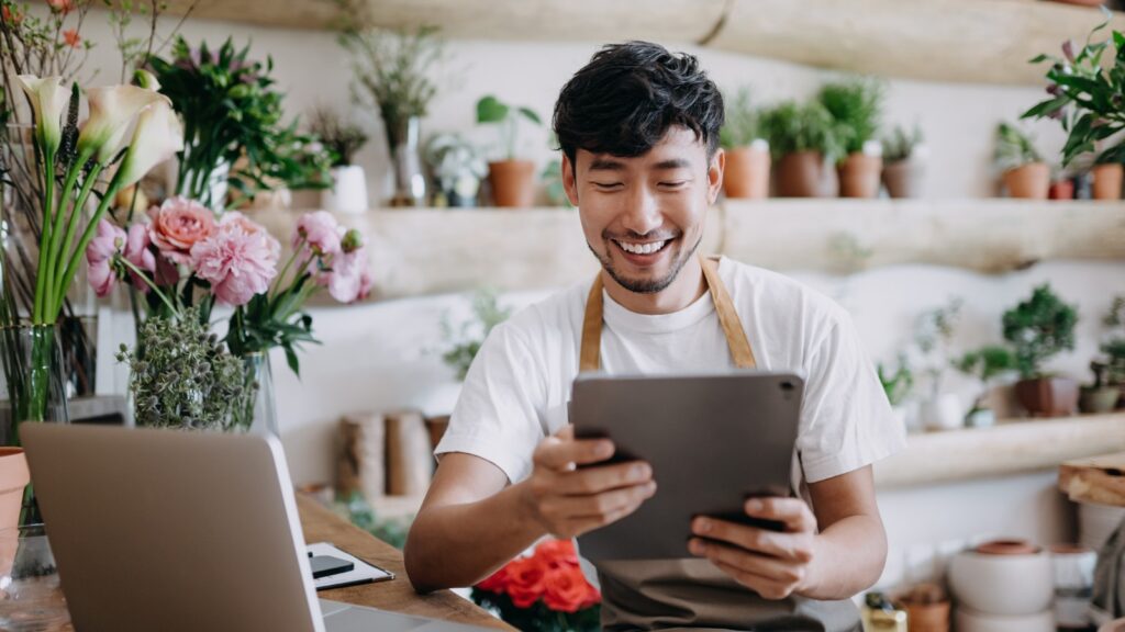 asian-male-florist-owner-of-small-business-flower-shop-using-digital-picture
