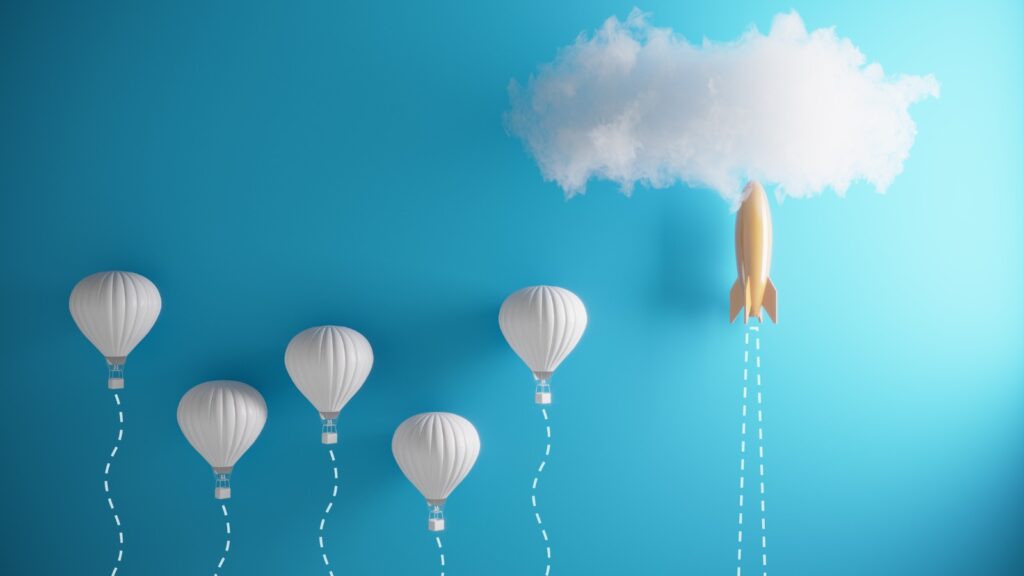 5 hot air balloons next to a rocket