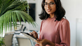 asian woman looking at tablet