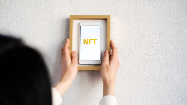 framed phone with NFT on screen