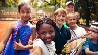 A group photo of several young children from different backgrounds taking a selfie
