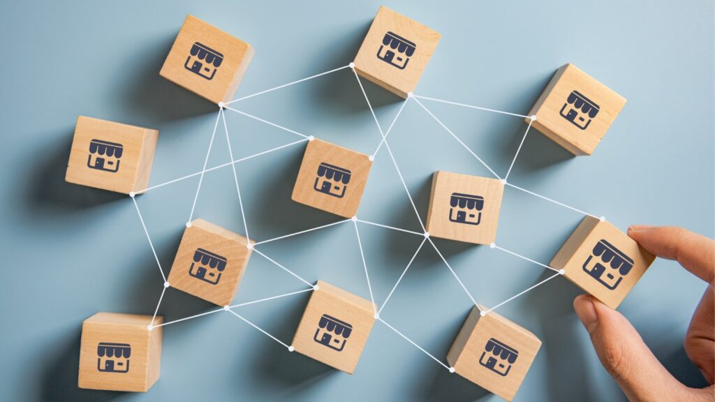 Woman hand choose wood blog with franchise marketing system in global network connection. Franchise business concept.