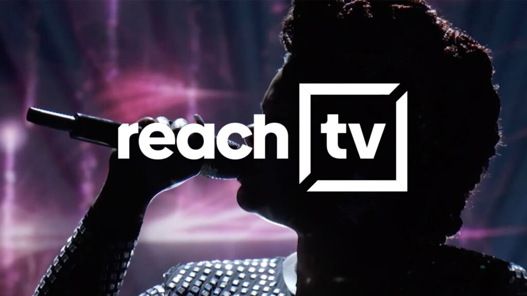 Image of the ReachTV logo over someone singing into a microphone