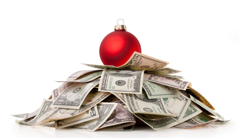 holiday ornament atop a pile of money