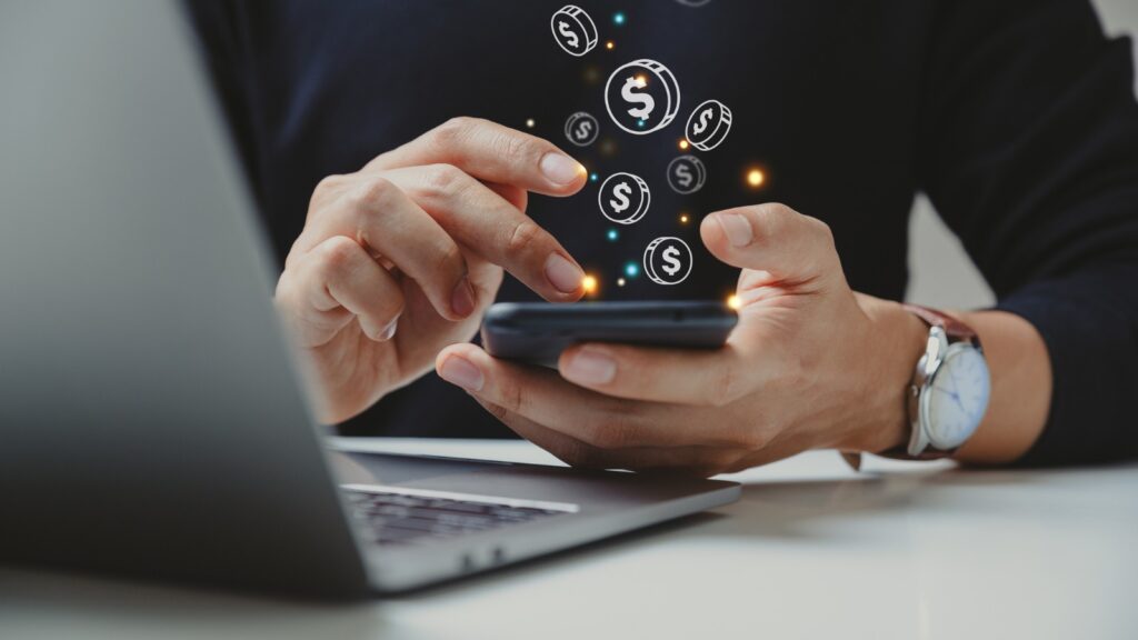 Hand of businessman using smart phone with coin icon. stock photo