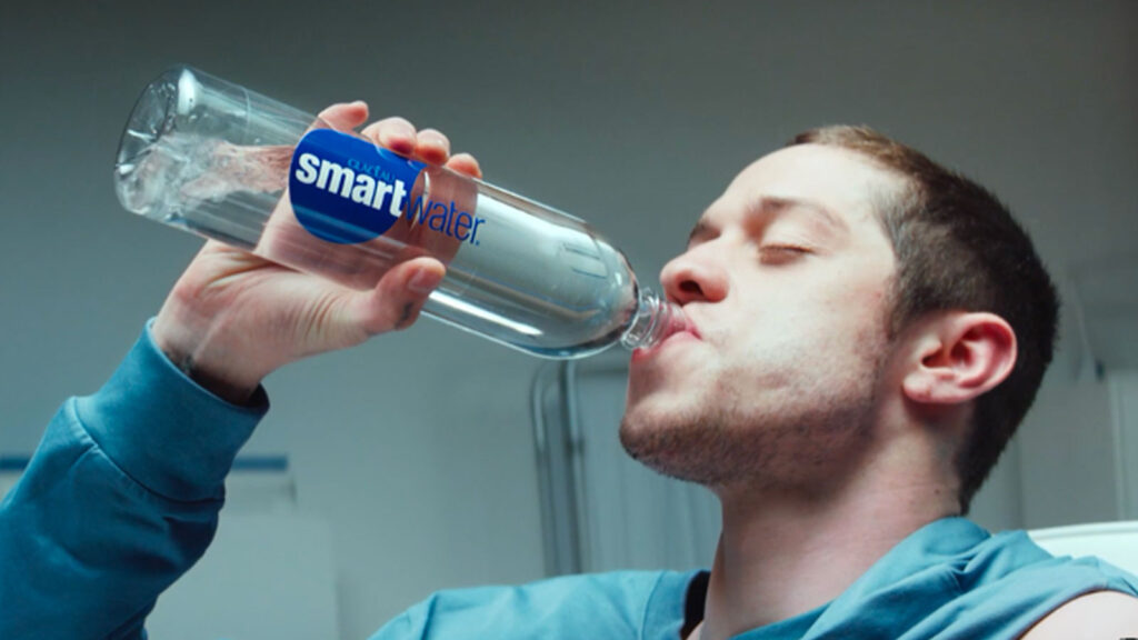 Man drinking from a Smartwater bottle