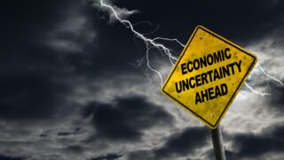 Economic Uncertainty Ahead Sign With Stormy Background stock photo